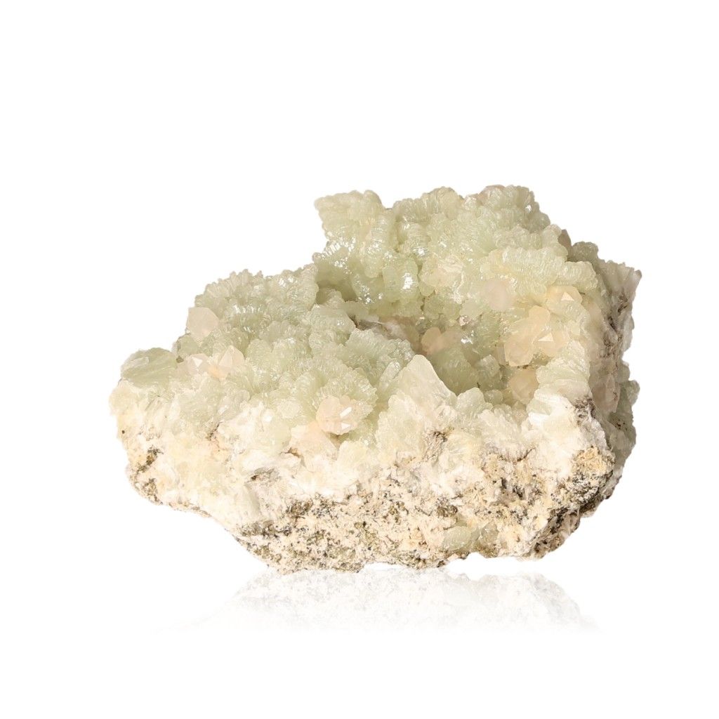 Prehnite druzy gemstone with soothing pale green crystals promoting inner peace and spiritual growth on a natural rock surface.