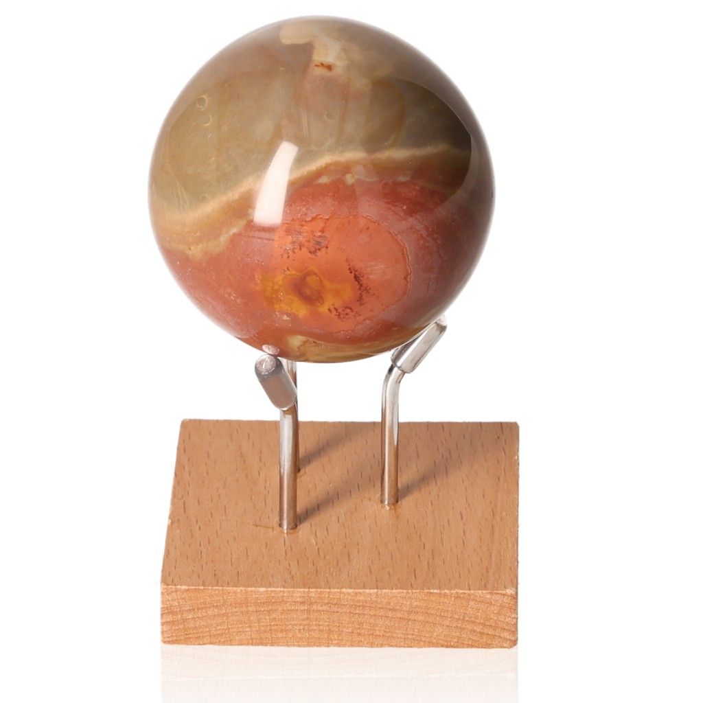 Polychrome Jasper Sphere with vibrant color patterns on a wooden stand, showcasing its energizing and grounding properties.