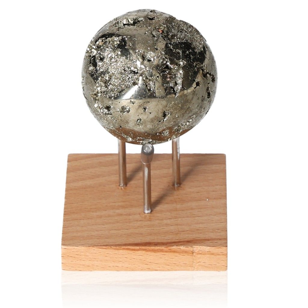 Pyrite sphere on wooden stand for motivation and courage with rustic design.