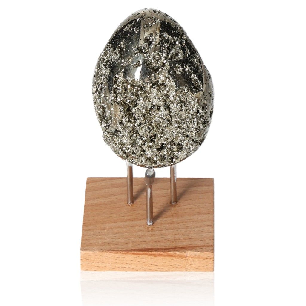 Sparkling pyrite egg on a wooden stand, promoting courage and independence. Perfect for goal achievement and new ideas.