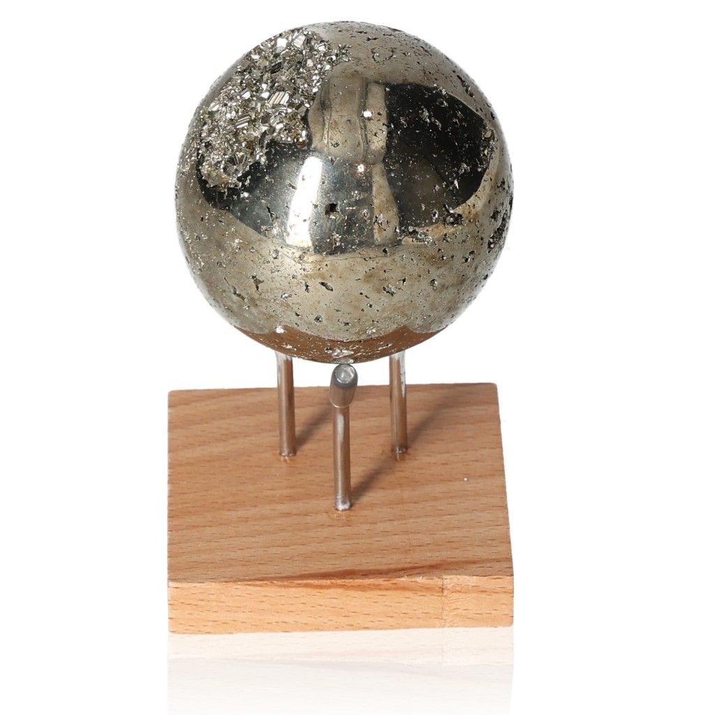 Shiny pyrite sphere on wooden stand, promoting independence and courage.