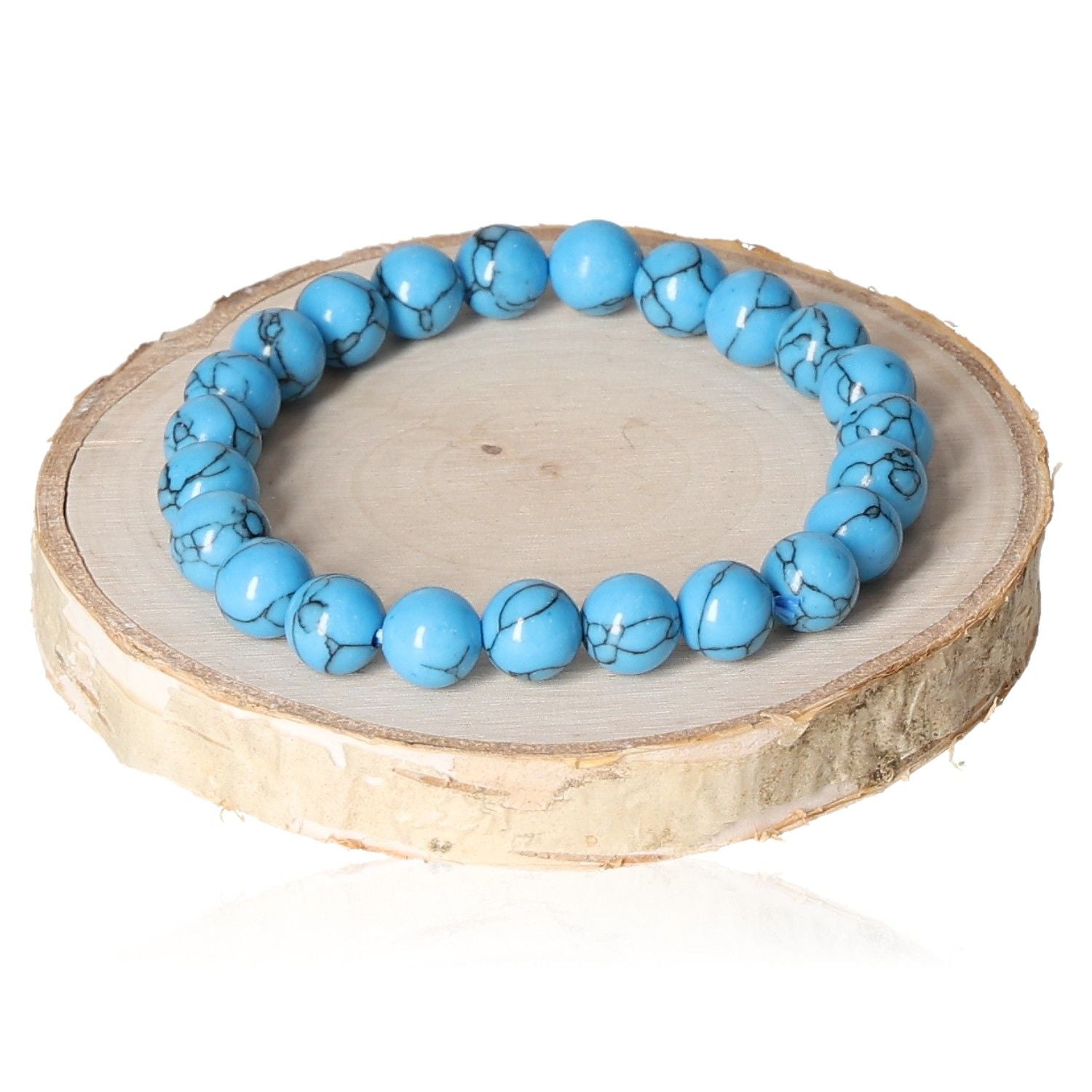 Turquenite bracelet with 8mm blue beads displayed on a wooden disk.