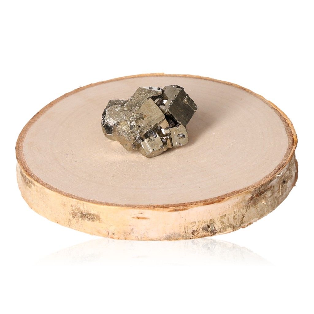 Pyrite druze crystal on wooden slice, promoting independence and courage, ideal for inspiring new ideas and motivation.