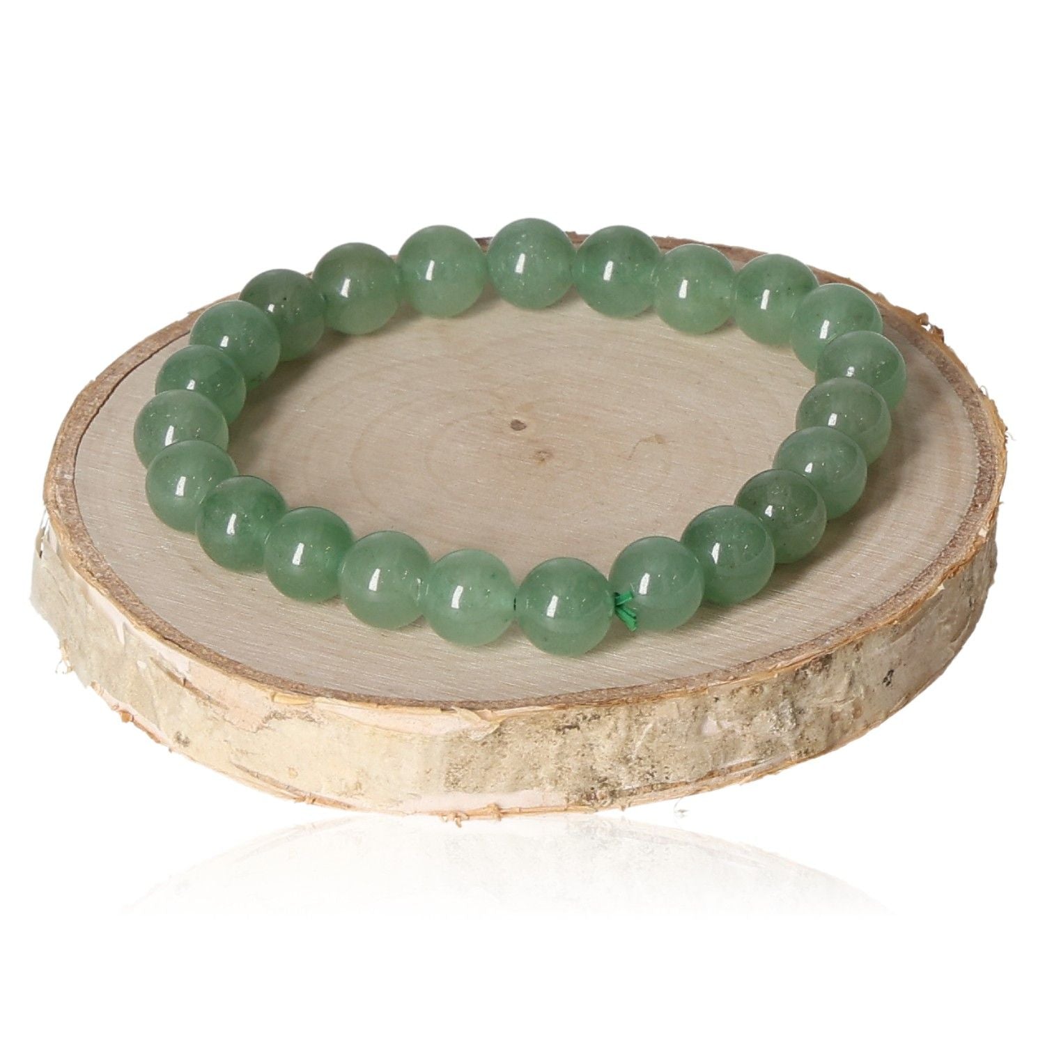 Aventurine bracelet with 8mm green beads displayed on a wooden disc.