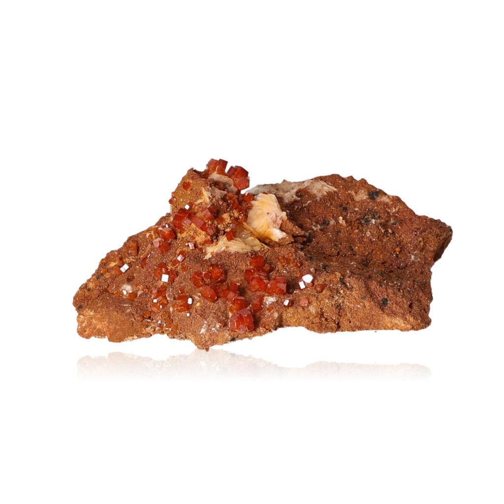 Vanadinite druze with hexagonal reddish-brown crystals on a stone surface, showcasing bold colors and geometric shapes.