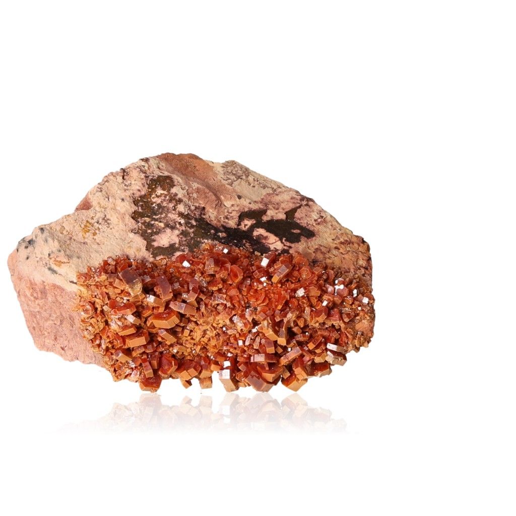 Vanadinite druze with vibrant hexagonal crystals, showcasing reddish-brown hues and a glassy surface.