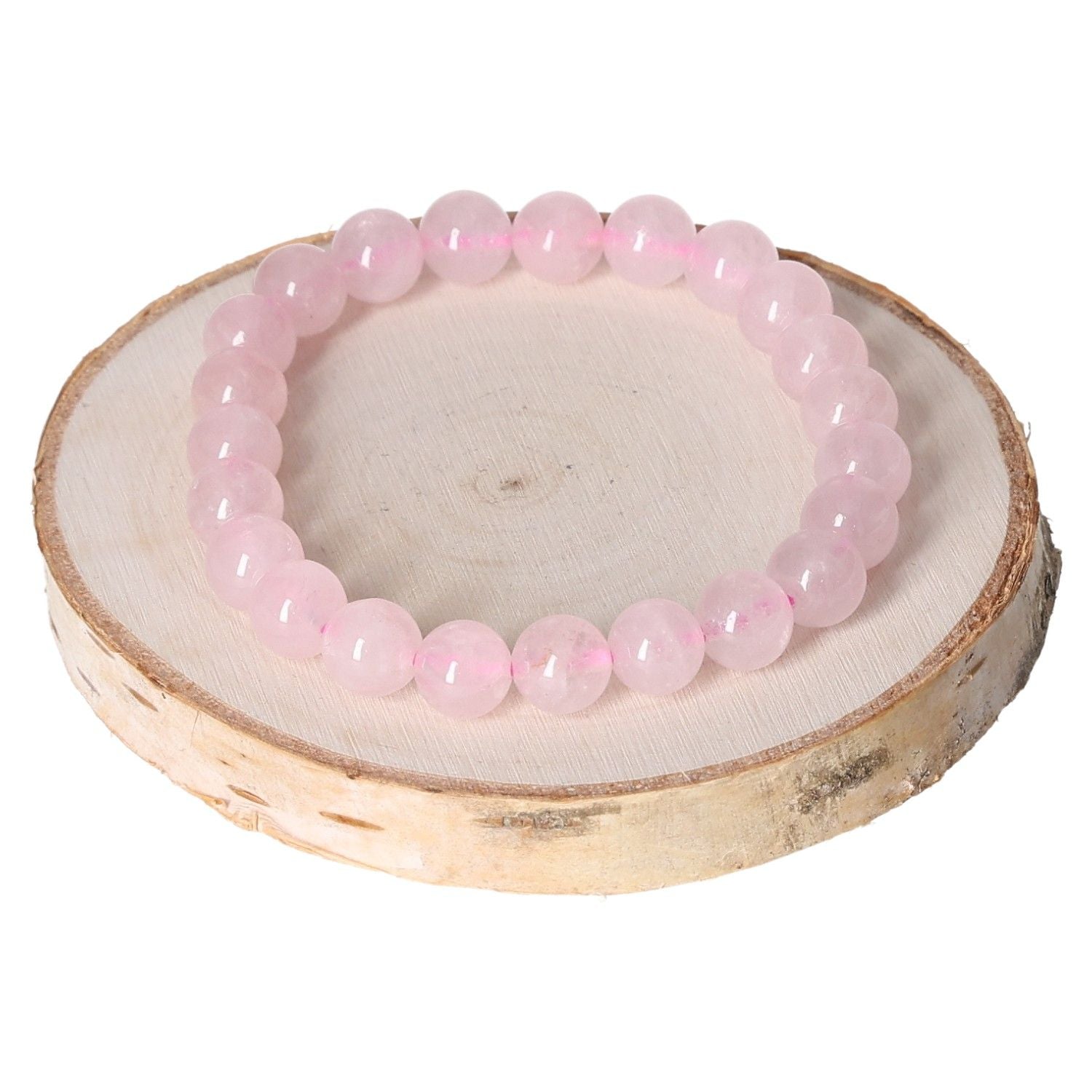 Rose Quartz Bracelet with 8mm beads displayed on a wooden slab, offering a stylish and calming accessory for any outfit.