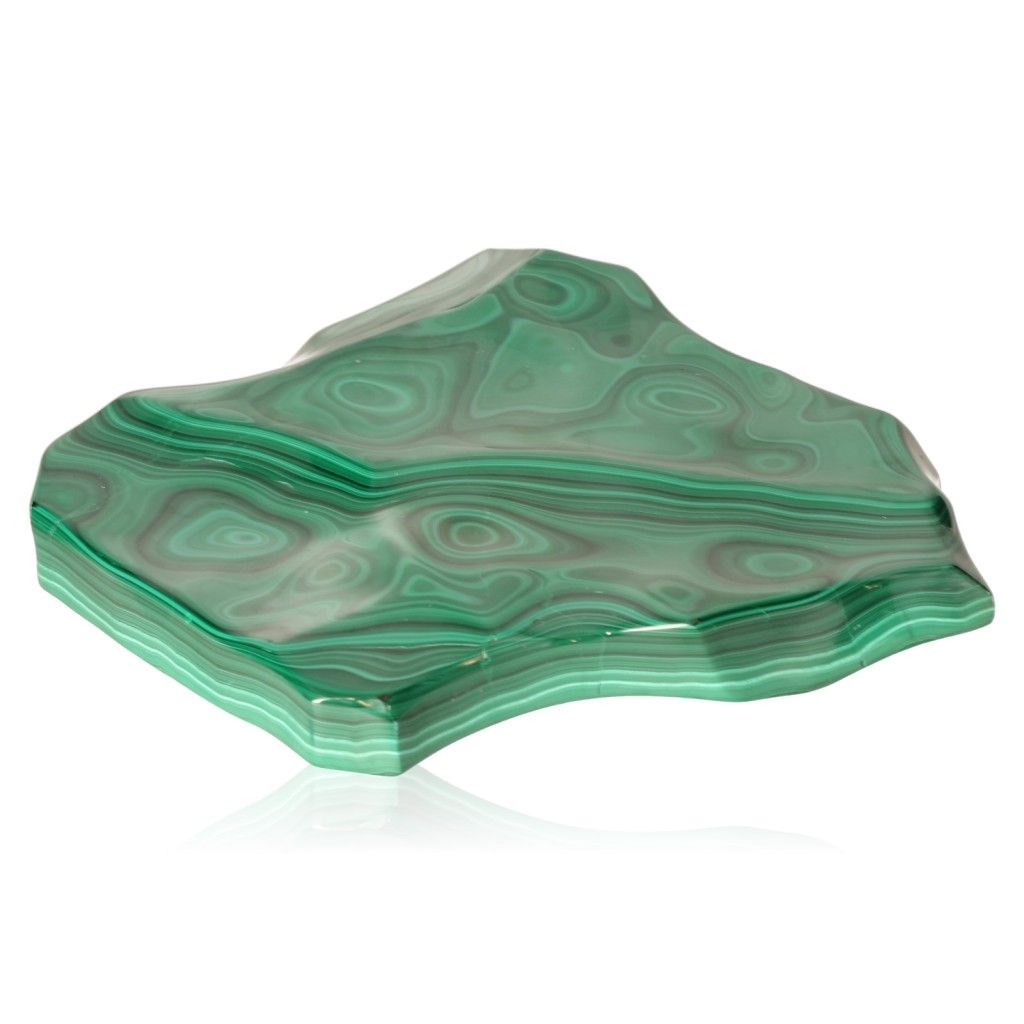 Polished malachite stone displaying green swirls, known for its soothing and energizing properties, promoting courage and harmony.