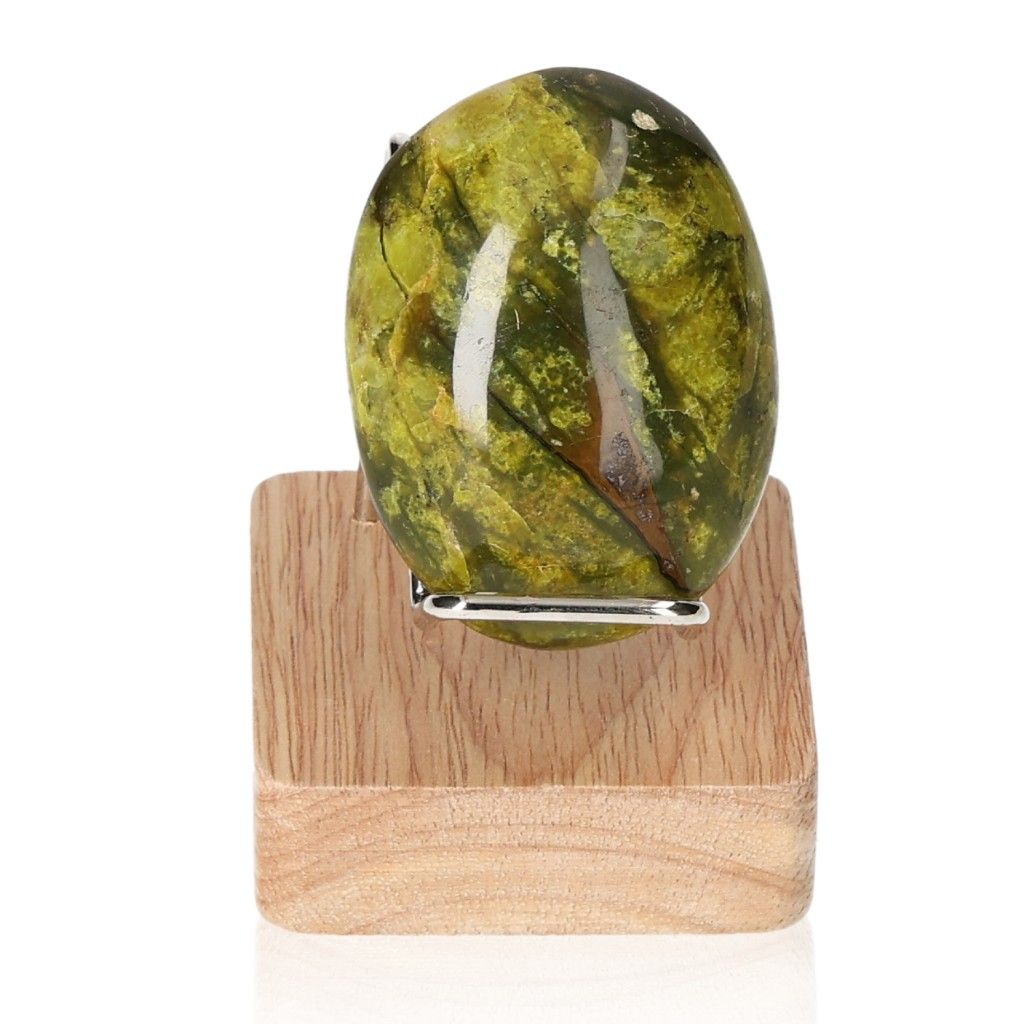 Green Opal Freeform gemstone with vibrant hues on a wooden stand, symbolizing renewal, healing, and emotional balance.