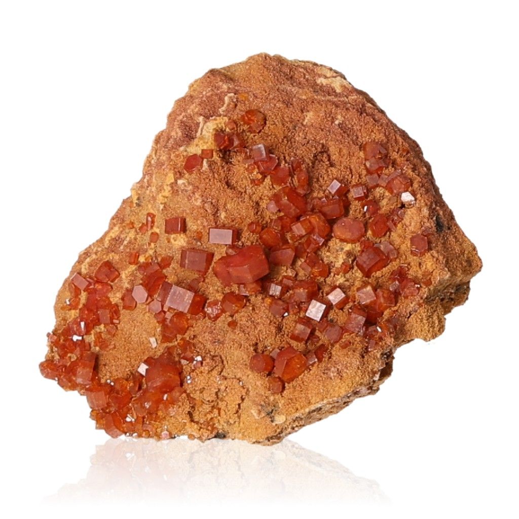 Vanadinite druze stone with vibrant reddish-brown hexagonal crystals and a glassy surface, showcasing bold colors and geometric shapes.