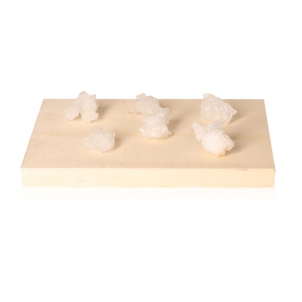 Quartz Druze stones on a wooden tray, showcasing various crystal formations for energetic and spiritual healing.