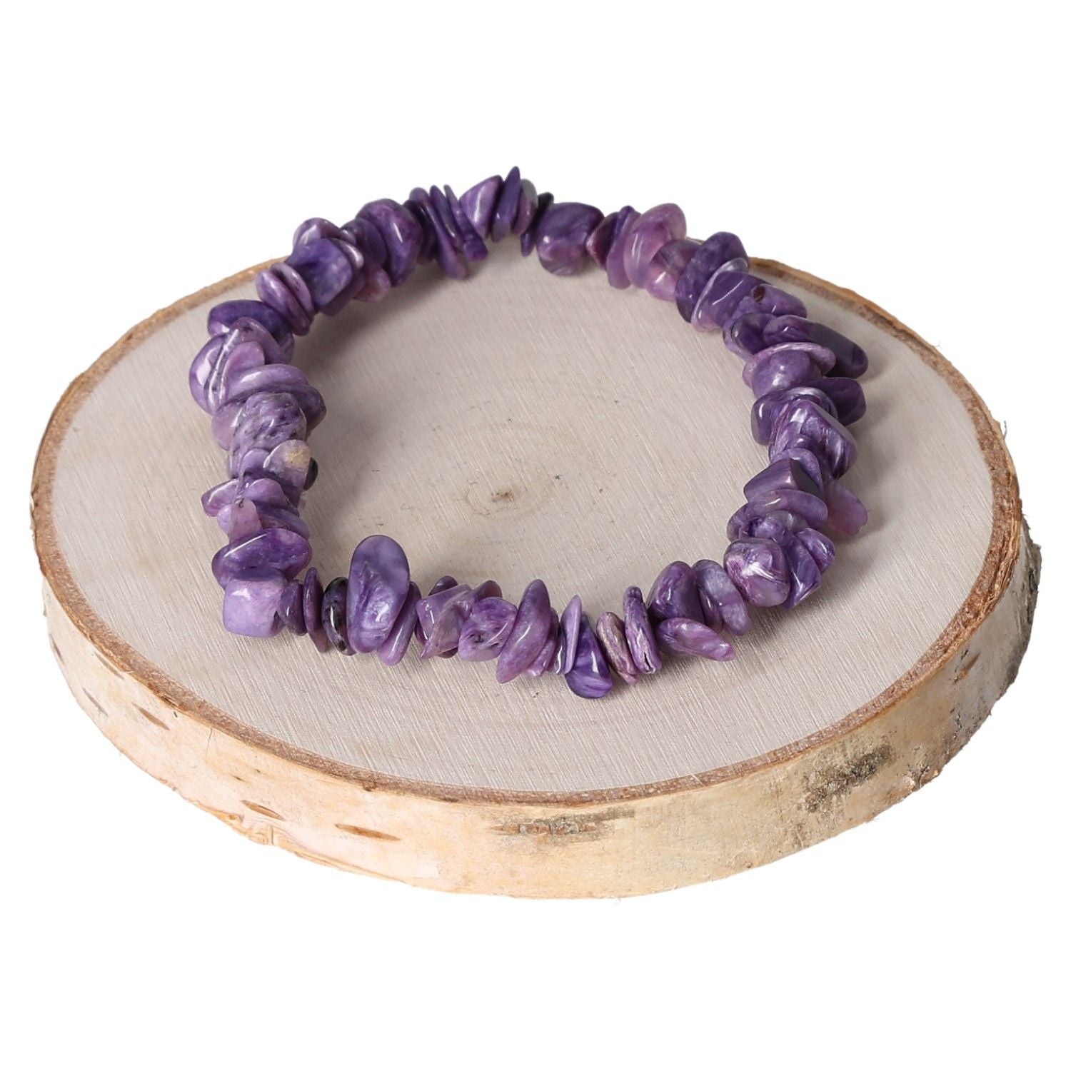 Purple charoite bracelet with chip-style beads on a rustic wood background.