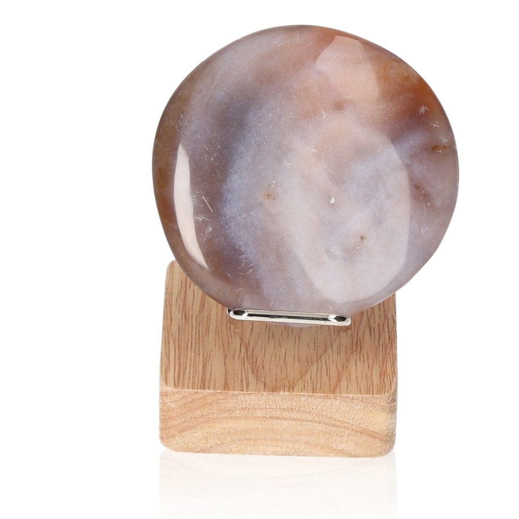 Carnelian palm stone on a wooden stand, energy booster for motivation and strength, ideal for achieving goals and facing challenges.